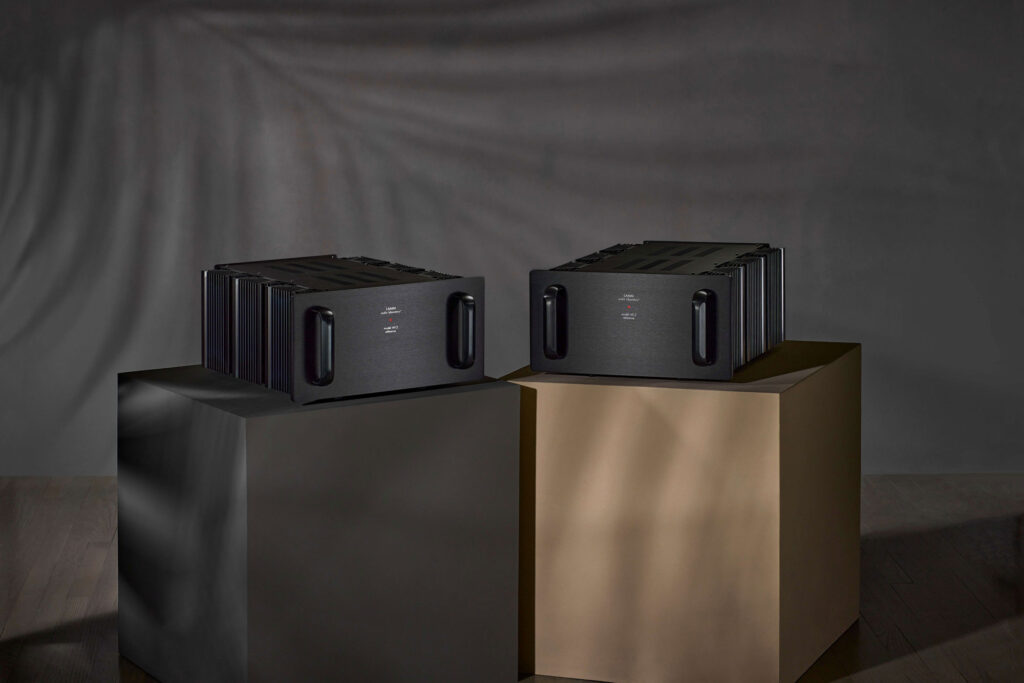 LAMM M1.2 Power Amplifier on black and beige pillars against a black background